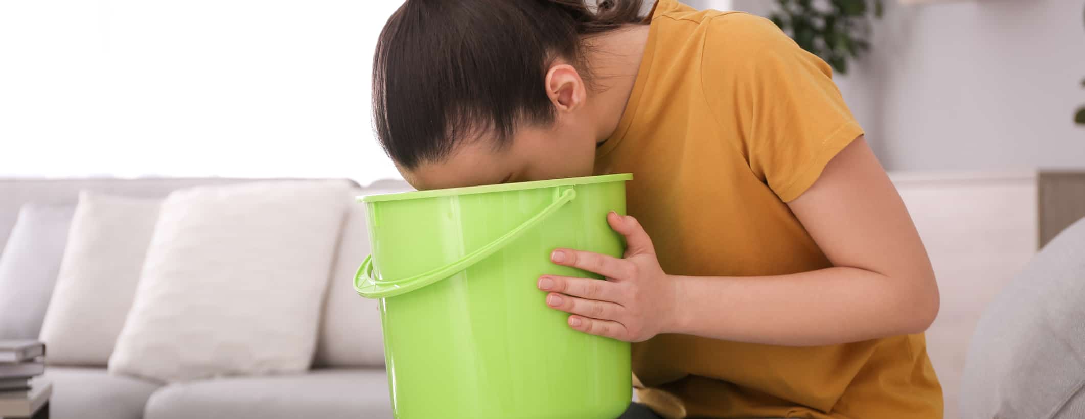 Person using a bucket to be sick into.